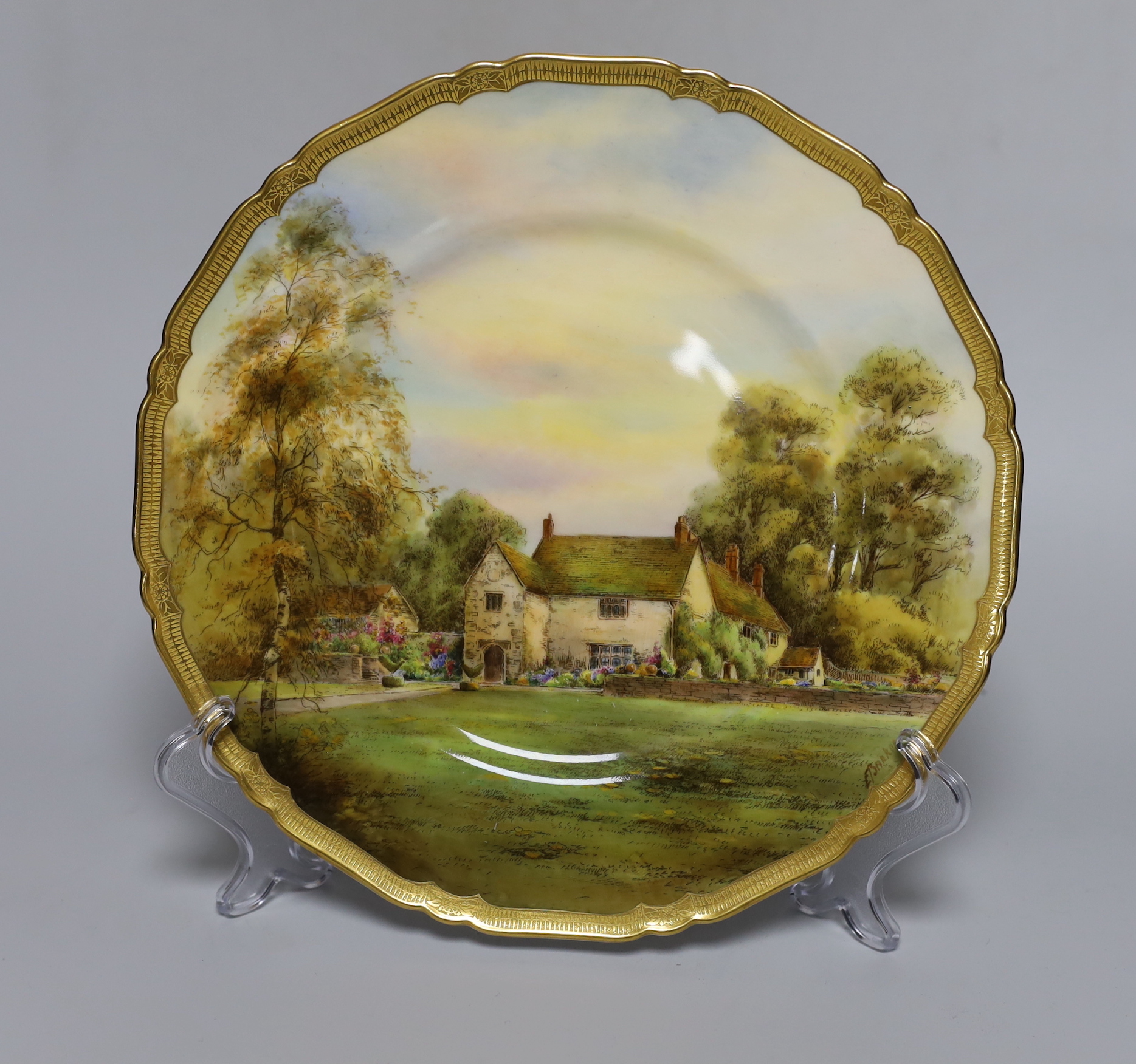 A Royal Worcester plate, painted with Lugrave Manor by E. Barker, signed, date mark for 1929